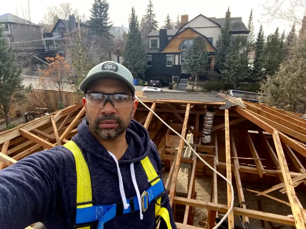 Tori Sealy in a safety harness on a roof that is being rebuilt